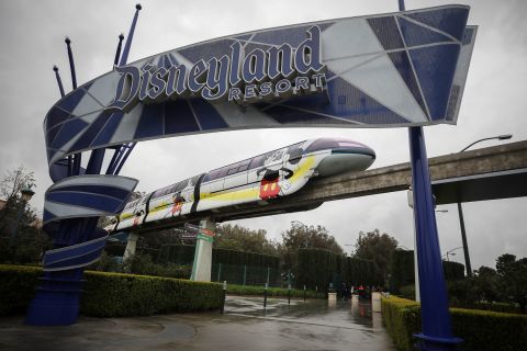 The monorail passes an entrance gate to Disneyland in Anaheim, California, on March 13.