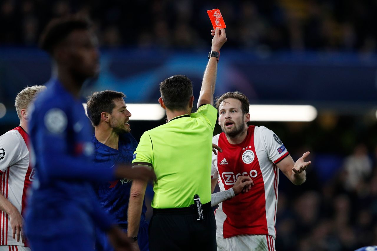 Ajax's Dutch defender Daley Blind (R) reacts as he is shown a red card by Italian referee Gianluca Rocch