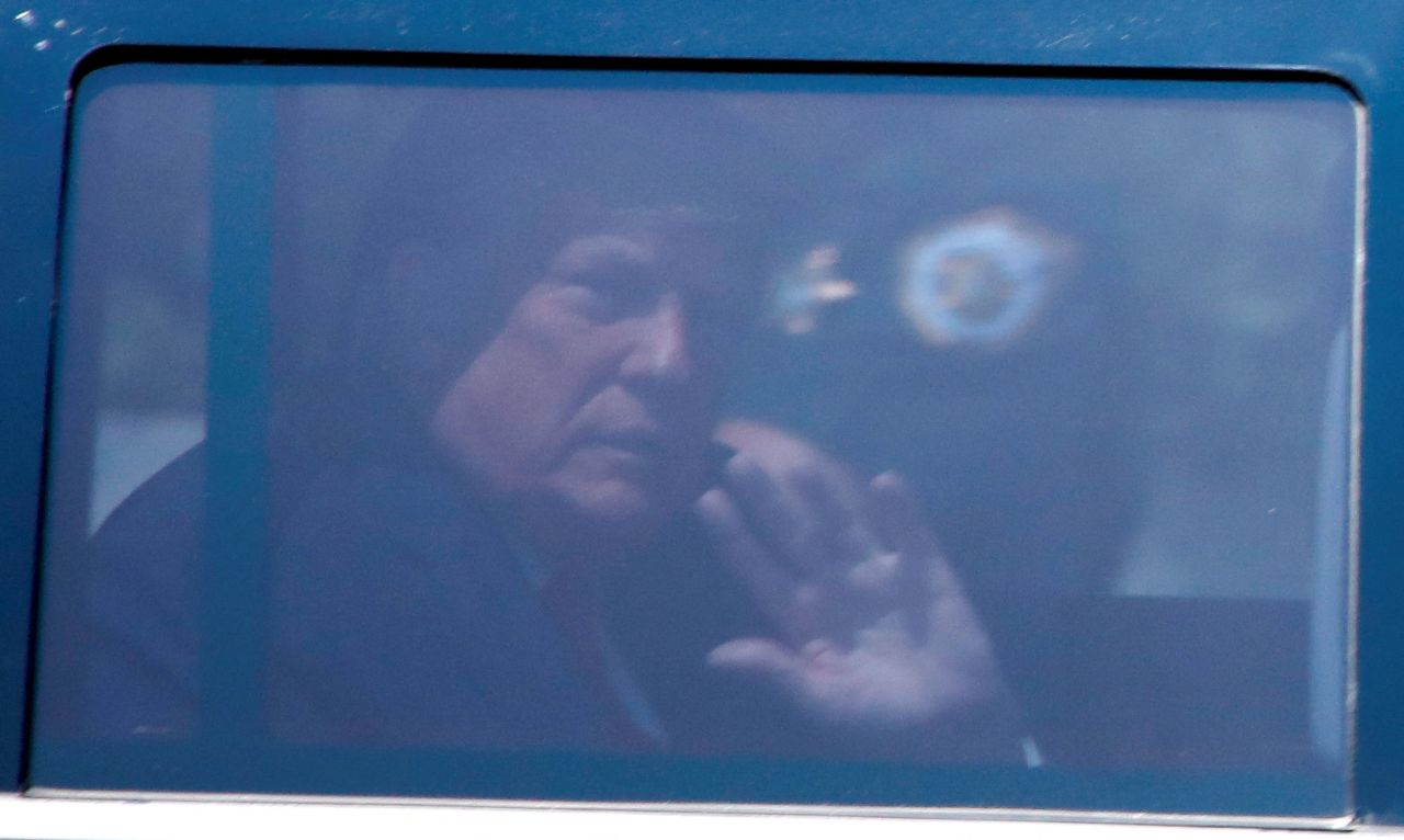 Former President Donald Trump waves from a vehicle as he leaves his Mar-a-Lago home on Monday.
