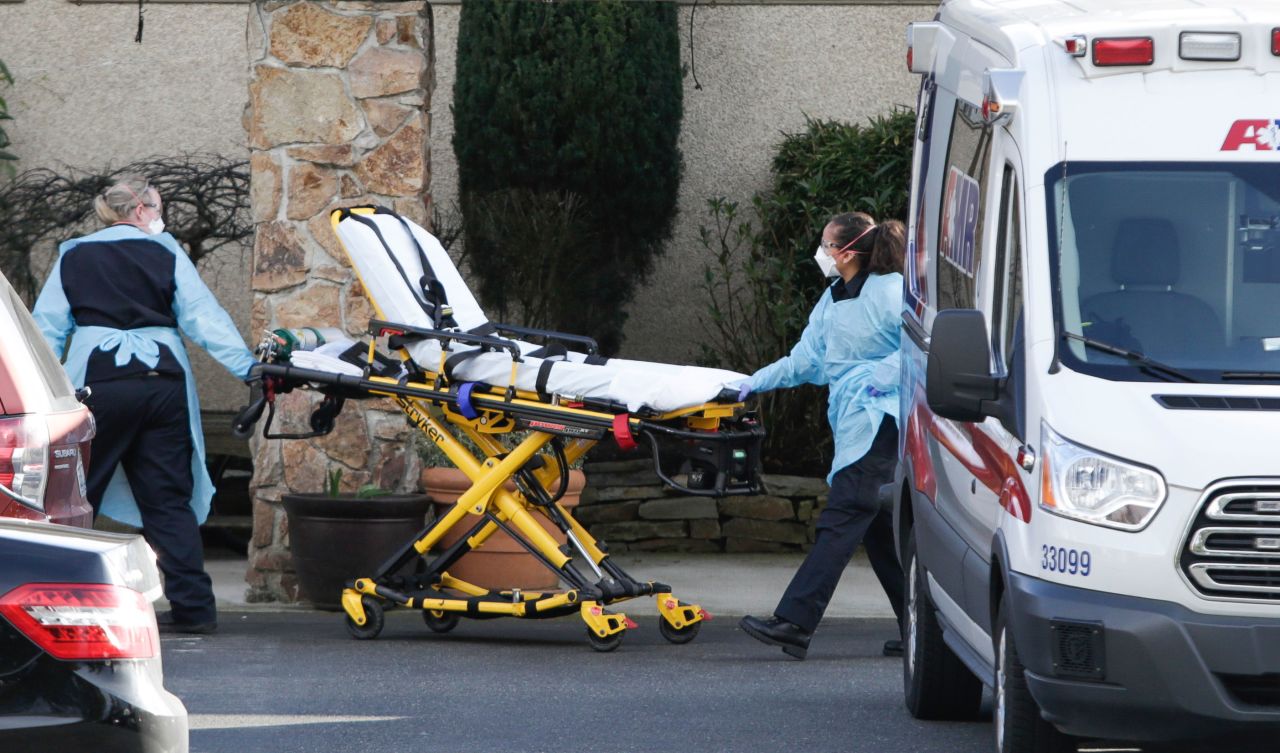 Medical workers take a stretcher into the Life Care Center of Kirkland in Washington on February 29.