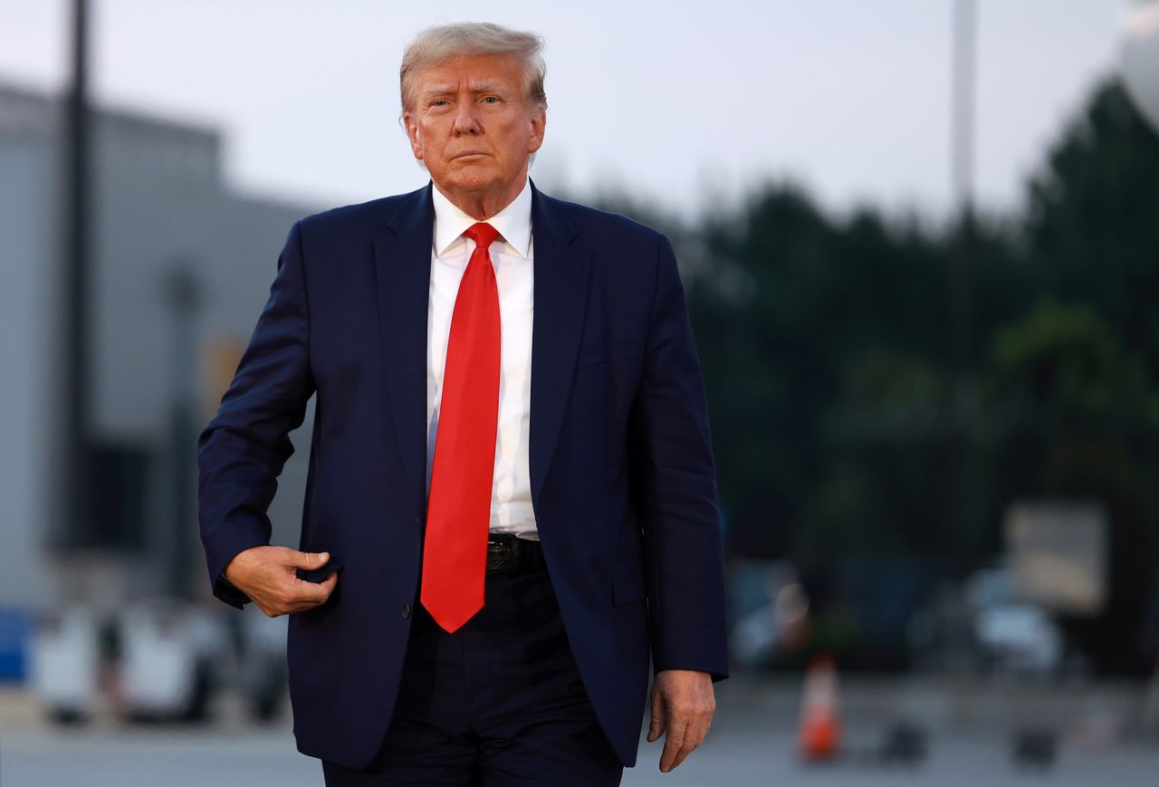 Former President Donald Trump arrives at Atlanta Hartsfield-Jackson International Airport after being booked at the Fulton County jail on August 24, in Atlanta, Georgia. 