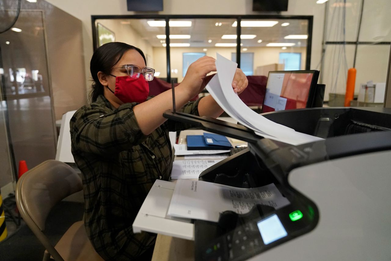 A county election worker scans ballots at a tabulating area at the Clark County Election Department in Las Vegas on November 4.