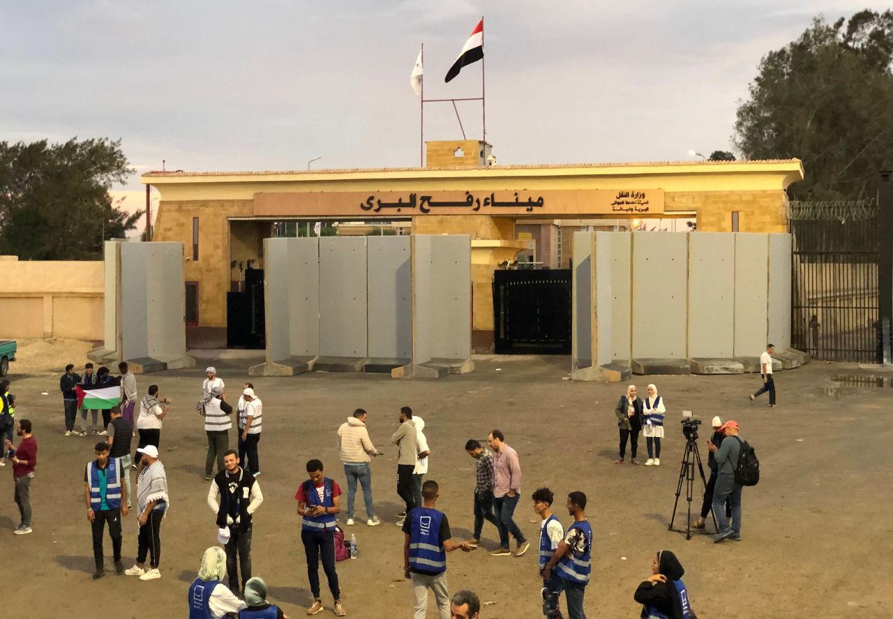 Volunteers from humanitarian organizations wait outside the Rafah crossing in Egypt, on October 17. 