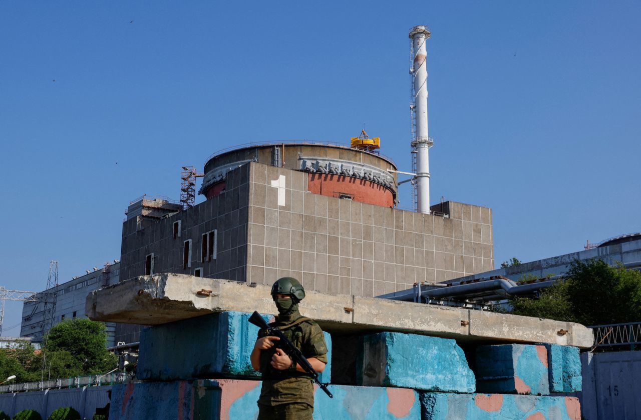 A Russian service member stands guard at a checkpoint near the Zaporizhzhia nuclear power plant outside Enerhodar on June 15.