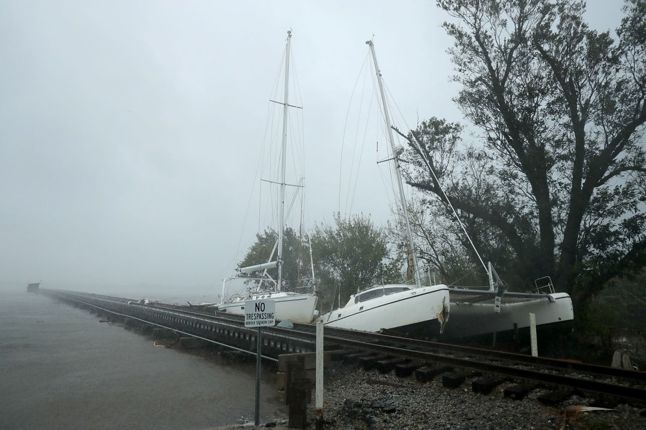 Broken from their moorings, boats are wrecked against a railroad bridge that crosses the Neuse River.