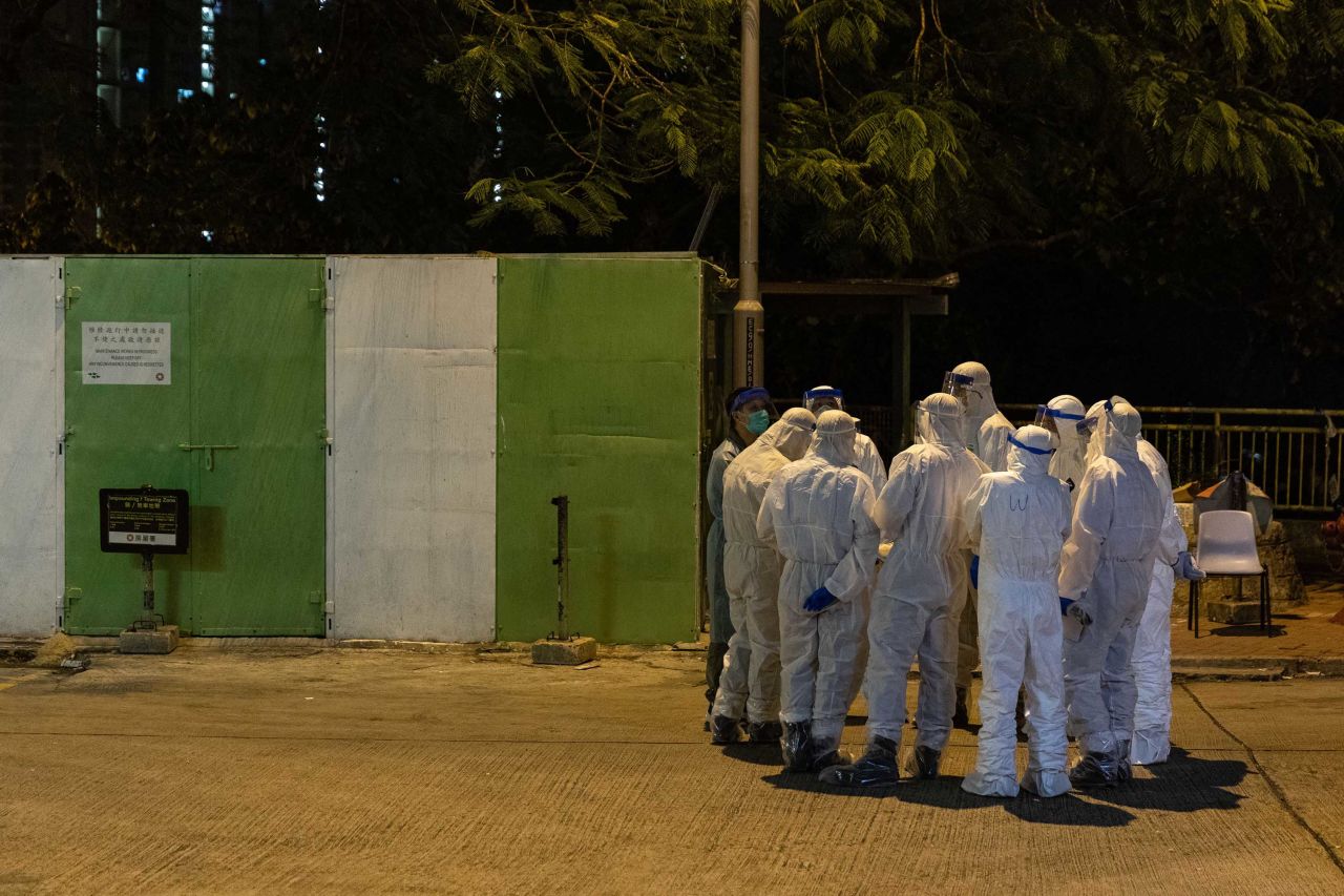 Health workers gather outside Hong Mei House in Hong Kong on Monday, after coronavirus cases were confirmed at the residential complex.