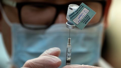 A pharmacist dilutes the Pfizer Covid-19 vaccine while preparing it to administer to staff and residents at the Goodwin House Bailey's Crossroads, a senior living community in Falls Church, Virginia, on December 30.