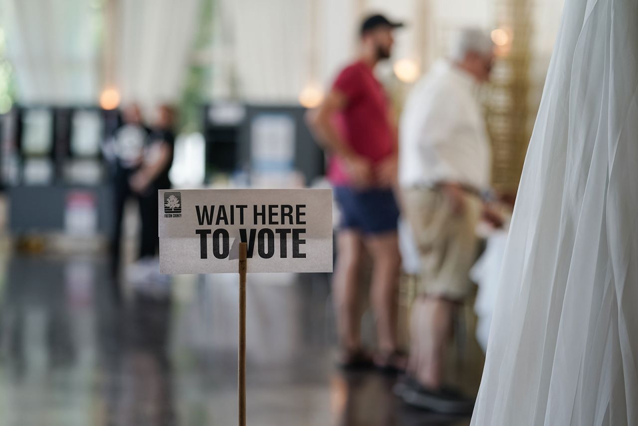 A 'Wait Here To Vote' sign is seen in a polling location as voters check in to cast ballots on May 21, in Atlanta, Georgia. 