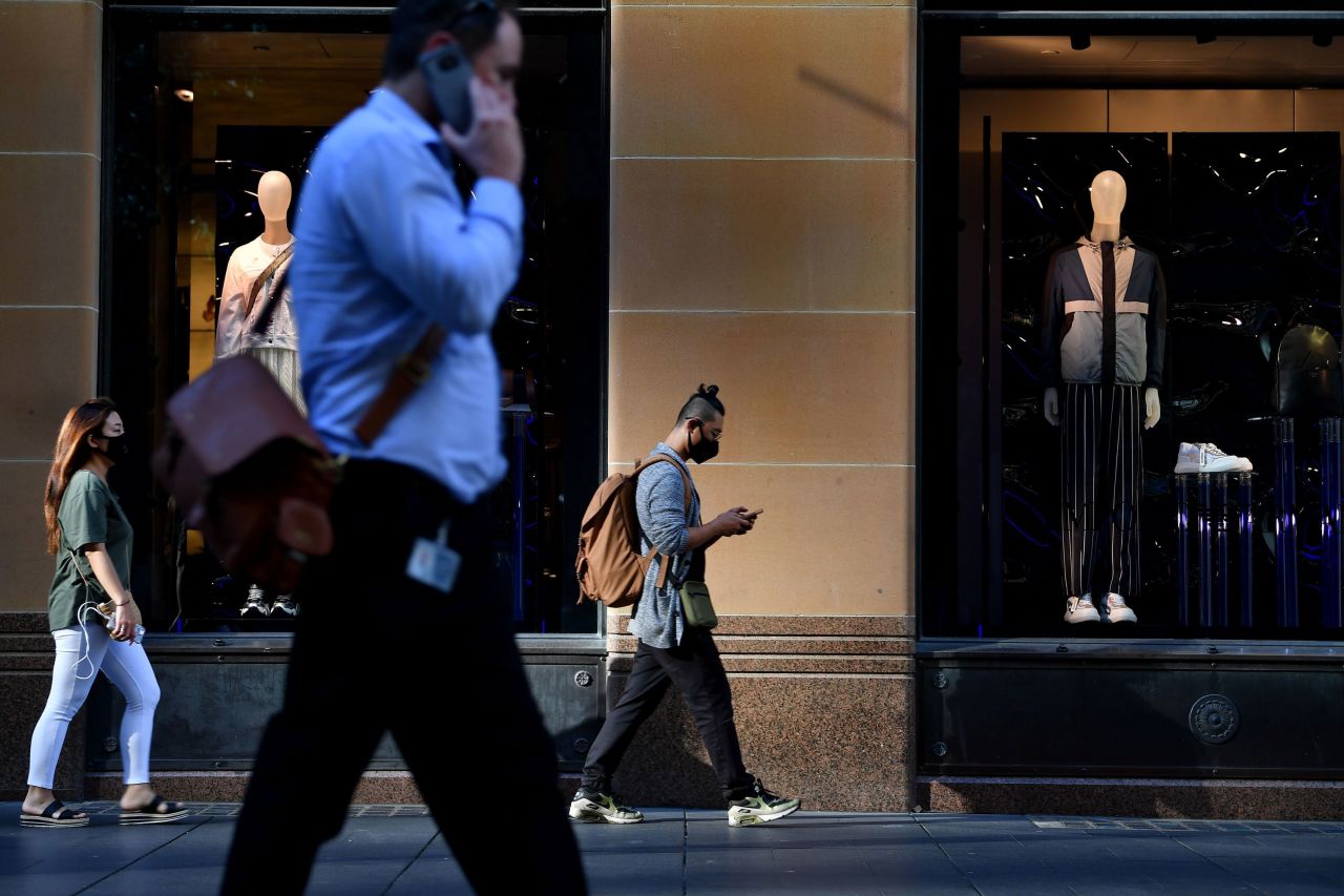 People walk past a retail store in Sydney on March 19.