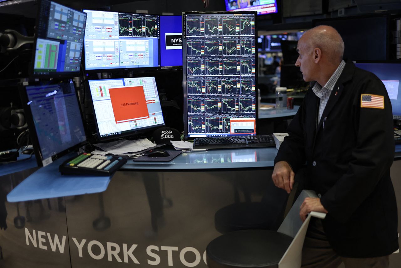 A trader works on the floor of the New York Stock Exchange (NYSE) ahead of the closing bell in New York City on August 5.