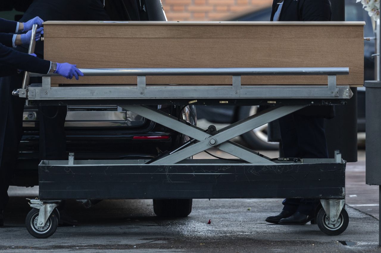 Undertakers move a coffin of a coronavirus victim at the La Almudena cemetery in Madrid, Spain, on March 23.