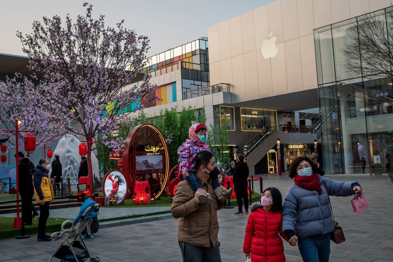 A family walks past an Apple store in Beijing on January 30.