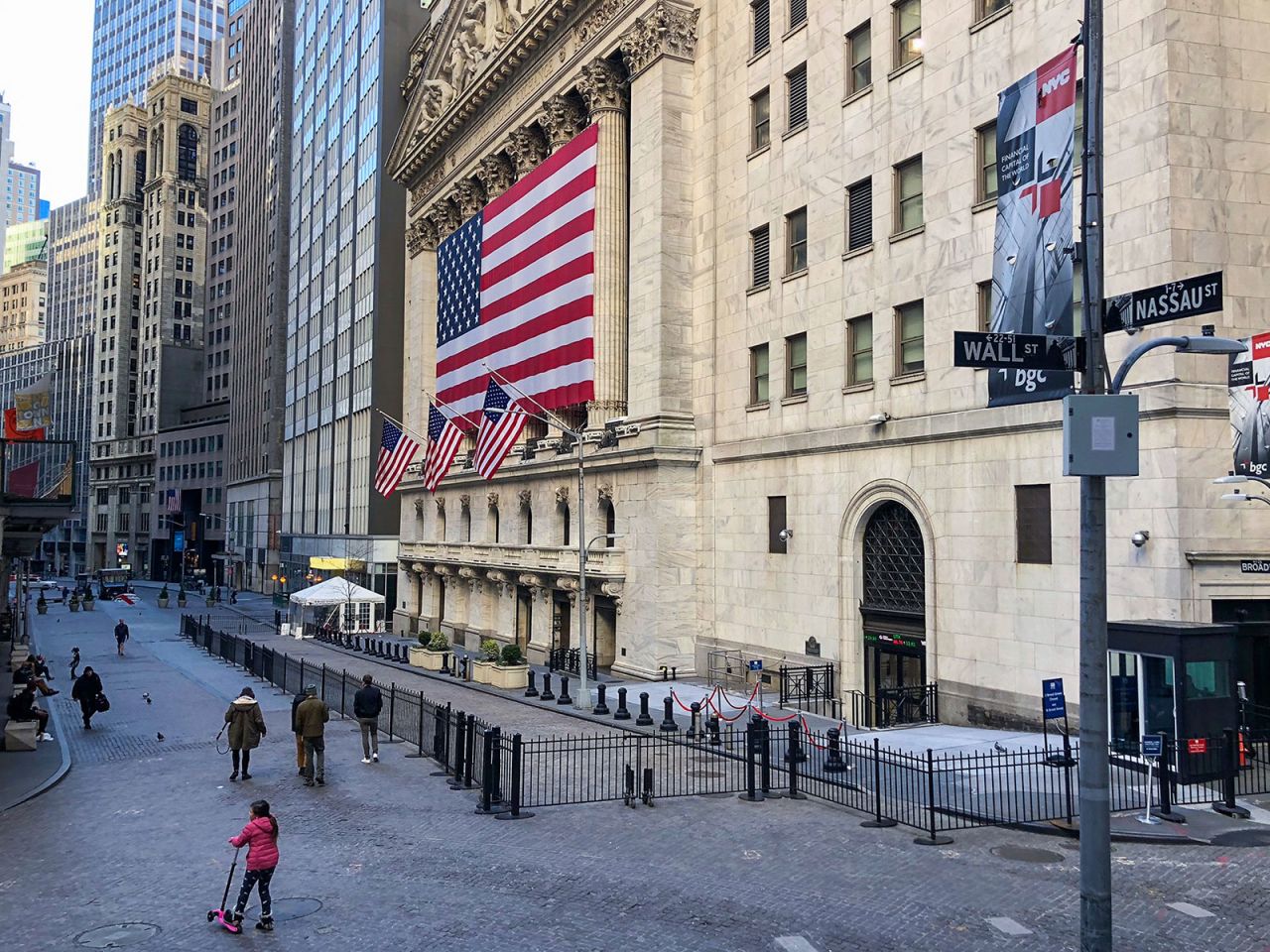 People walk in front of the New York Stock Exchange on March 24.