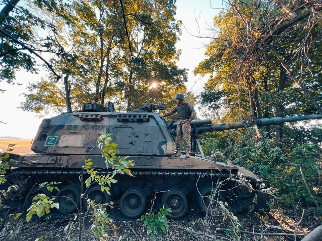 A Ukrainian service member stands on a Russian 2S19 Msta-S self-propelled howitzer captured during a counteroffensive operation in?Kharkiv?on Monday. 