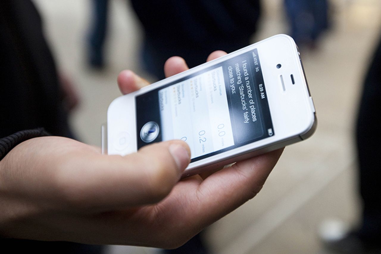 An Apple customer demonstrates the voice assistant program on his newly purchased iPhone 4s outside of an Apple Store in New York City on October 14, 2011.