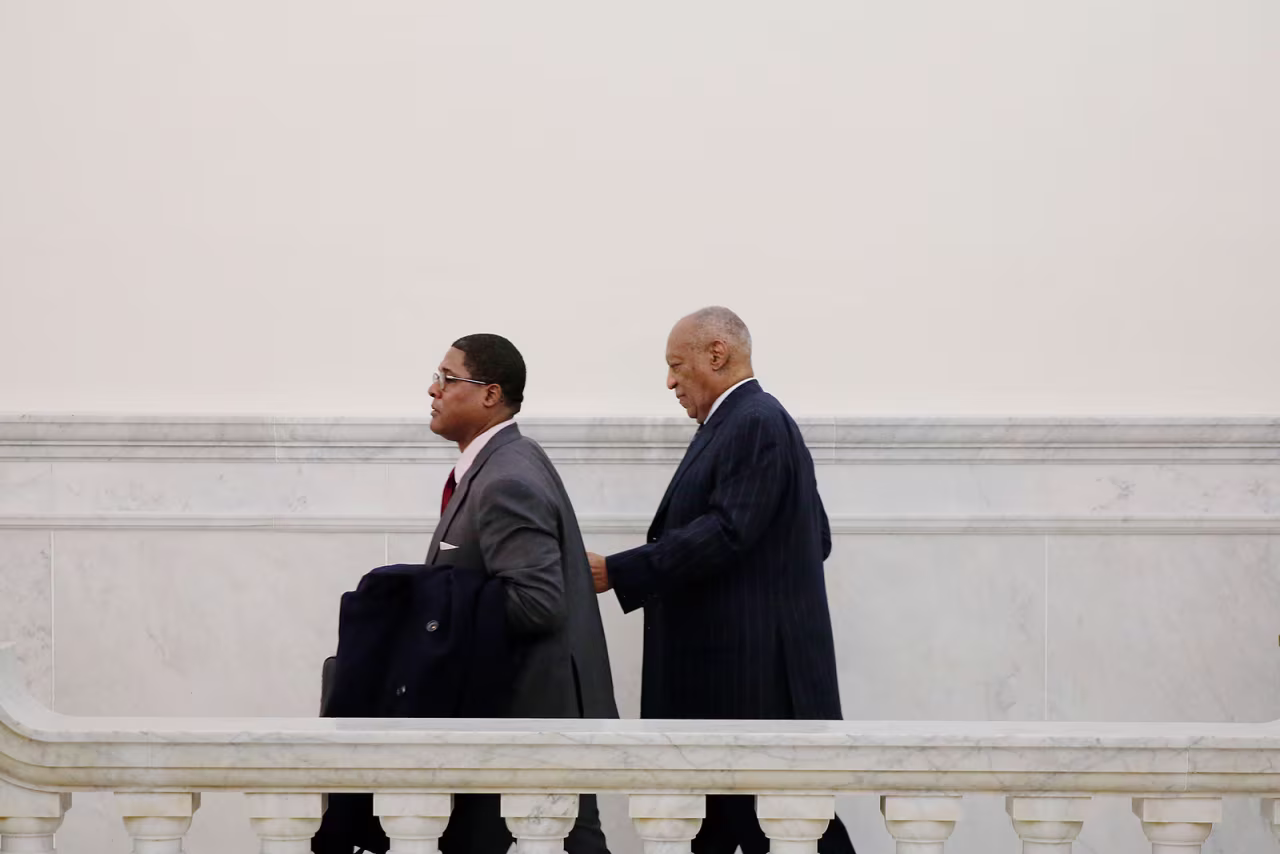 Bill Cosby, right, walks through the Montgomery County courthouse in 2018. 