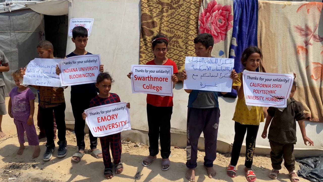 Children hold up banners, which express gratitude to pro-Palestinian students at college campuses across the US, in Deir al-Balah, Gaza, on Wednesday. 