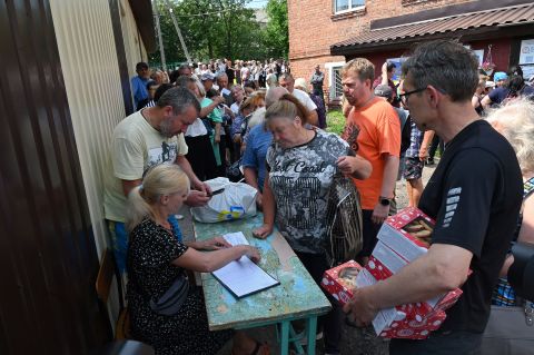 Volunteers distribute humanitarian aid in the town of Lyubotyn, Ukraine, on June 29.