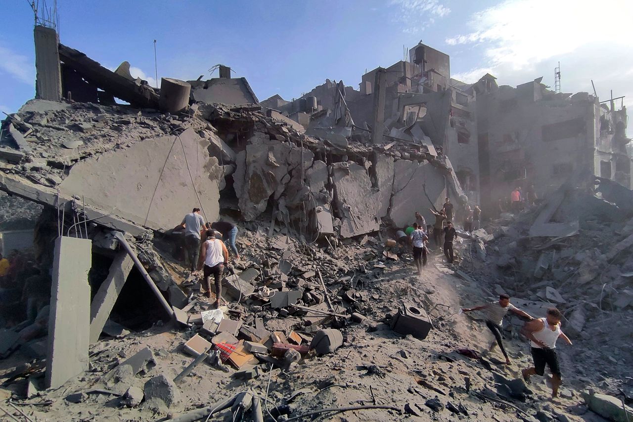 Palestinians inspect the site of a strike in Jabalya refugee camp in Gaza on October 31.