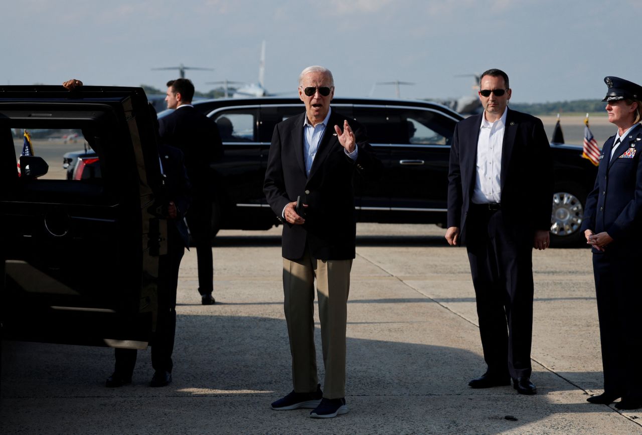 President?Joe?Biden?gestures as he disembarks Air Force One at Joint Base Andrews, Maryland, on Sunday.