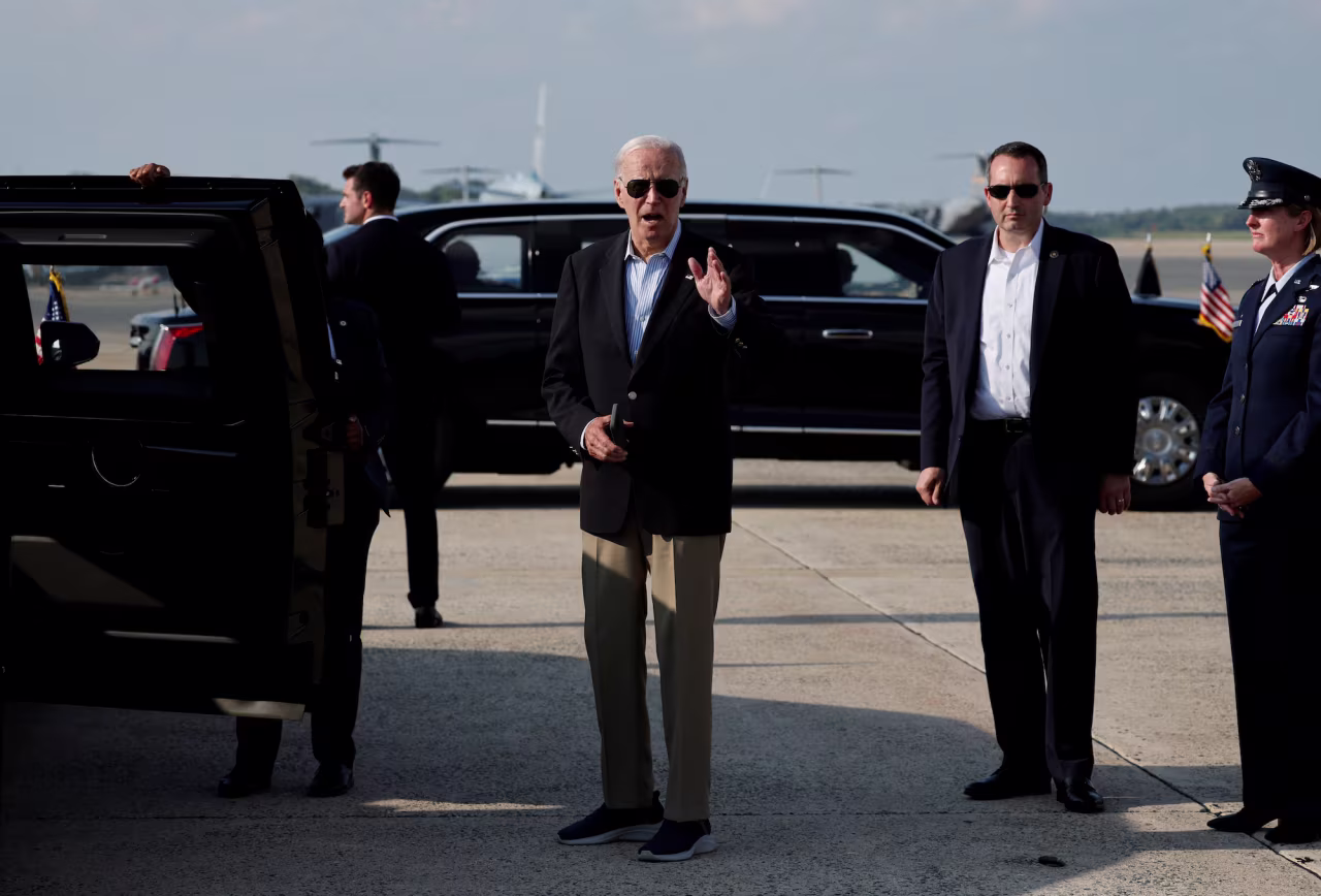 President Joe Biden gestures as he disembarks Air Force One at Joint Base Andrews, Maryland, on Sunday.