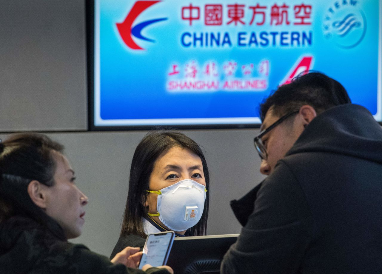 Passengers wait for standby tickets on a China Eastern flight to Shanghai, at Los Angeles International Airport on Sunday.