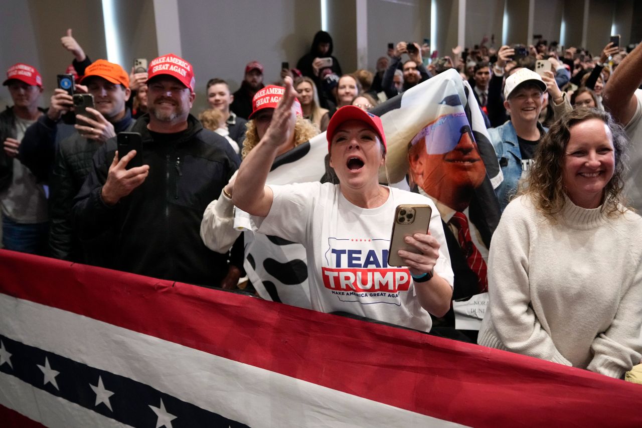 Supporters react as former President Donald Trump arrives at a rally in Indianola, Iowa, on Sunday.