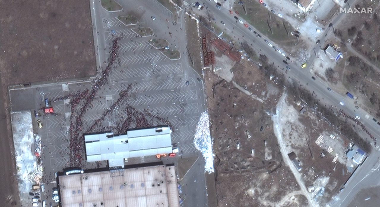 Hundreds of people gather in lines outside the Metro supermarket in western Mariupol.