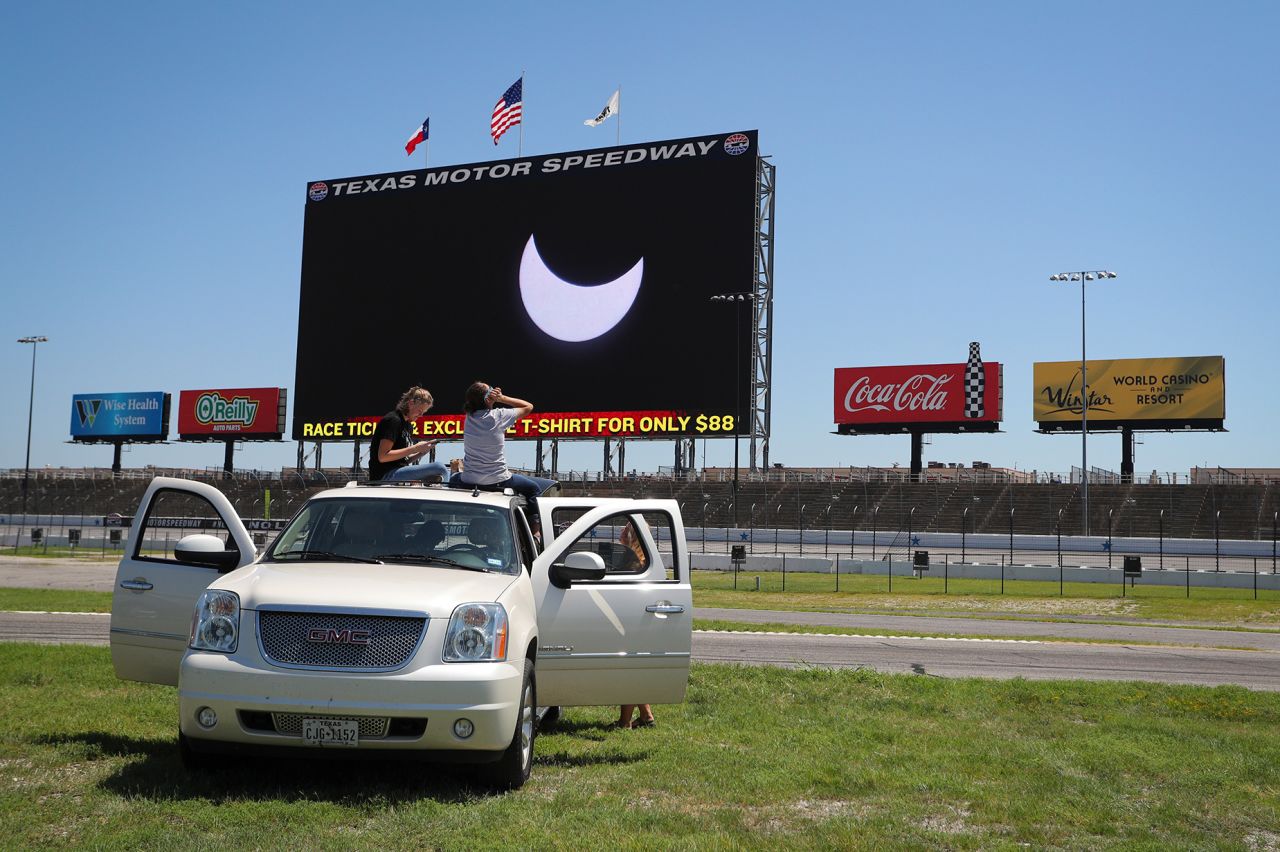 Spectators watch the solar eclipse at Texas Motor Speedway in Fort Worth, Texas, on August 21, 2017.