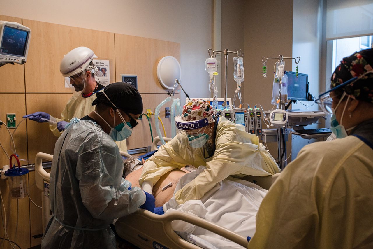 Healthcare workers prepare to prone a patient in the Covid-19 Intensive Care Unit overflow area at Providence Holy Cross Medical Center in Mission Hills, California, on Friday, February 5.