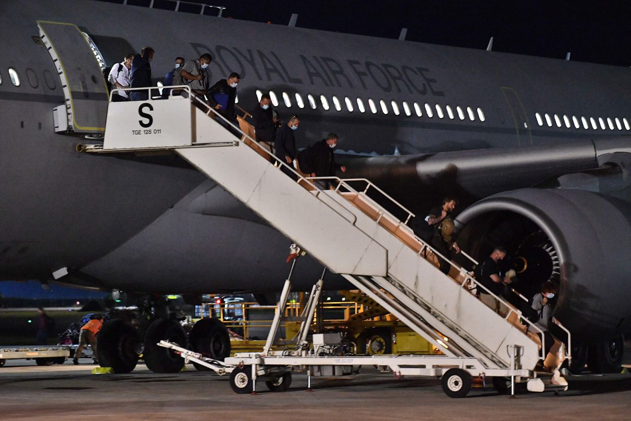 Passengers repatriated from Afghanistan disembark from an RAF Airbus KC2 Voyager aircraft after landing at RAF Brize Norton, southern England, on August 17.