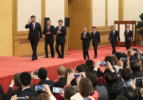 Xi Jinping and newly-elected members of the Central Committee arrive to meet the press at the Great Hall of the People in Beijing on October 25, 2017. 