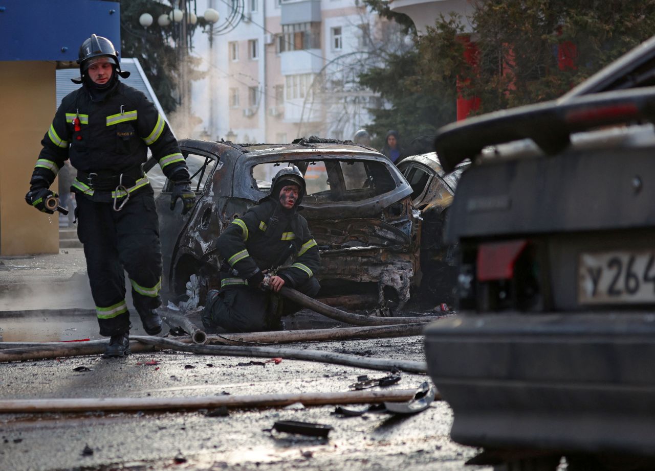 Firefighters work to extinguish burning cars following what Russian authorities say was a Ukrainian military strike in?Belgorod, Russia, on December 30. 