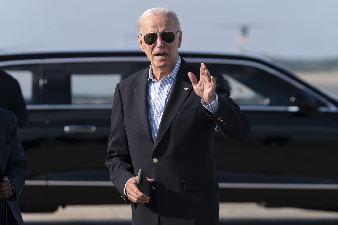 President Joe Biden talks to reporters upon his arrival to Joint Base Andrews, en route to the White House, on August 18.