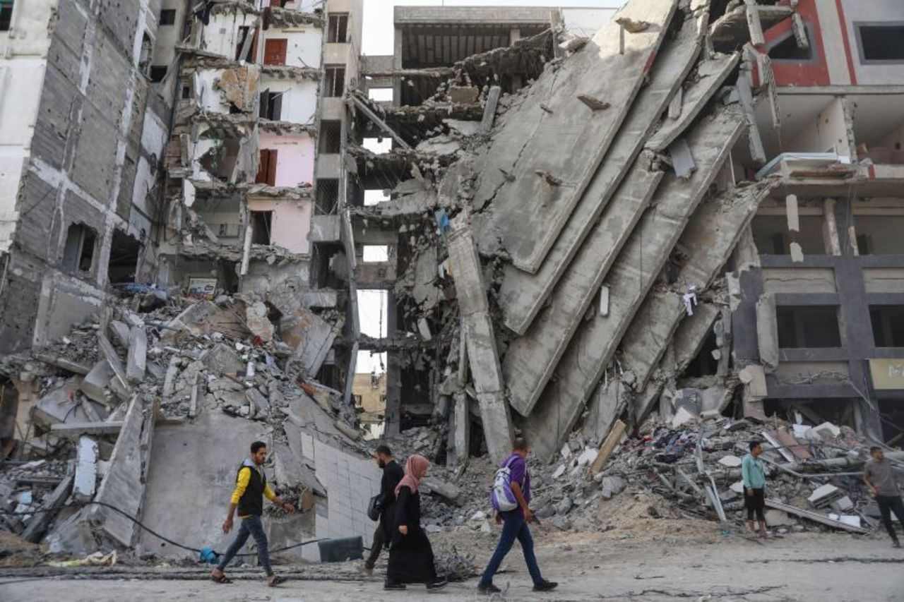 Palestinians walk through destruction in Gaza City on November 24, as the temporary truce between Israel and Hamas took effect. 