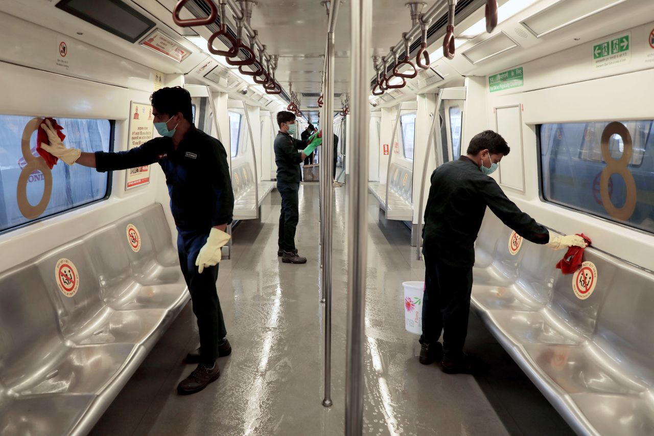 Workers disinfect the interior of a Delhi metro rail carriage at the Khyber Pass metro depot ahead of the resumption of services in New Delhi on Sunday, September 6. 