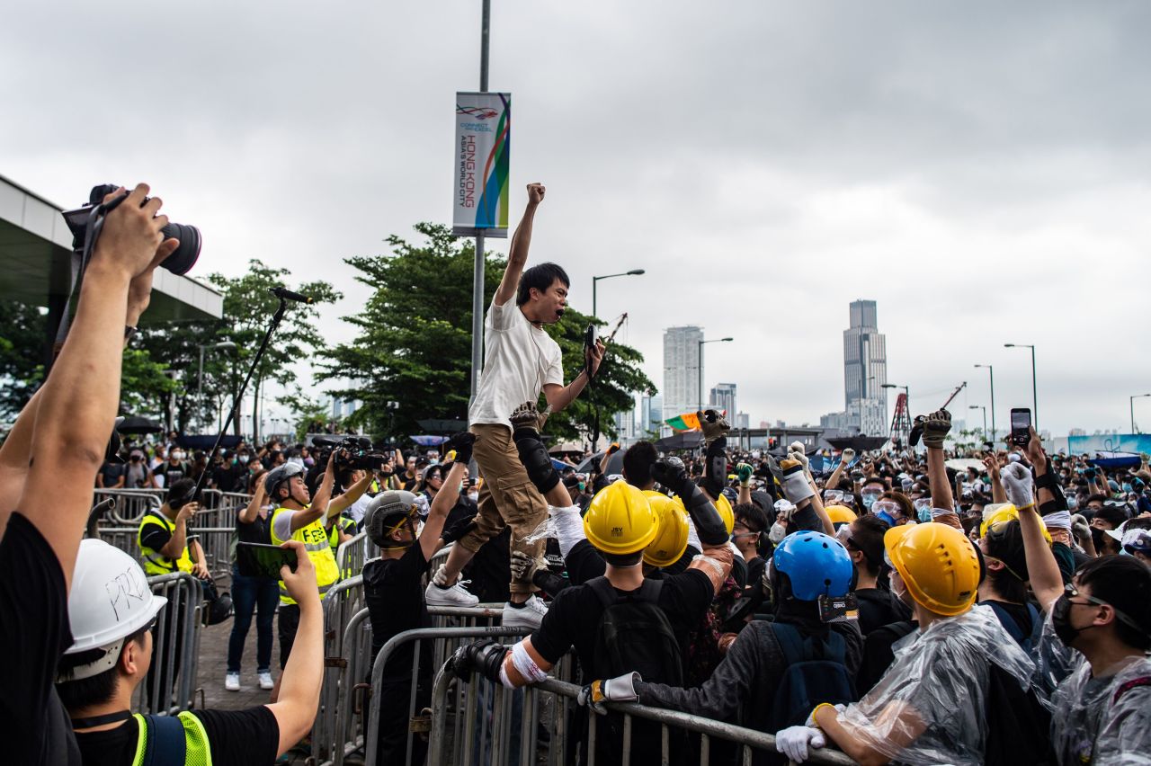 Pro-democracy lawmaker Roy Kwong chants slogans as protesters occupy outside Legislative Council.