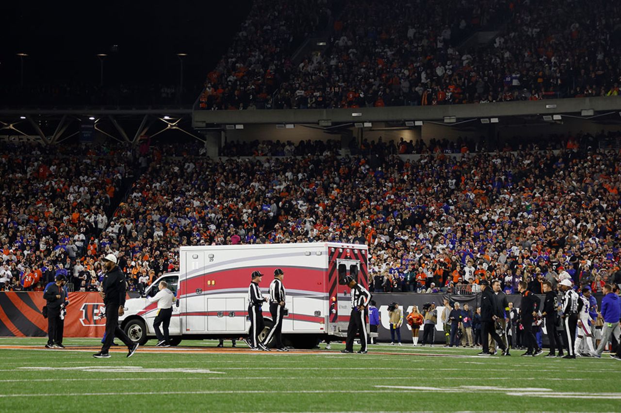 Fans look on as the ambulance leaves carrying Hamlin leaves the stadium.