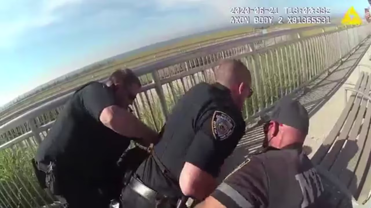 The video shows several officers arresting a man, with one officer appearing to put him in a chokehold. 