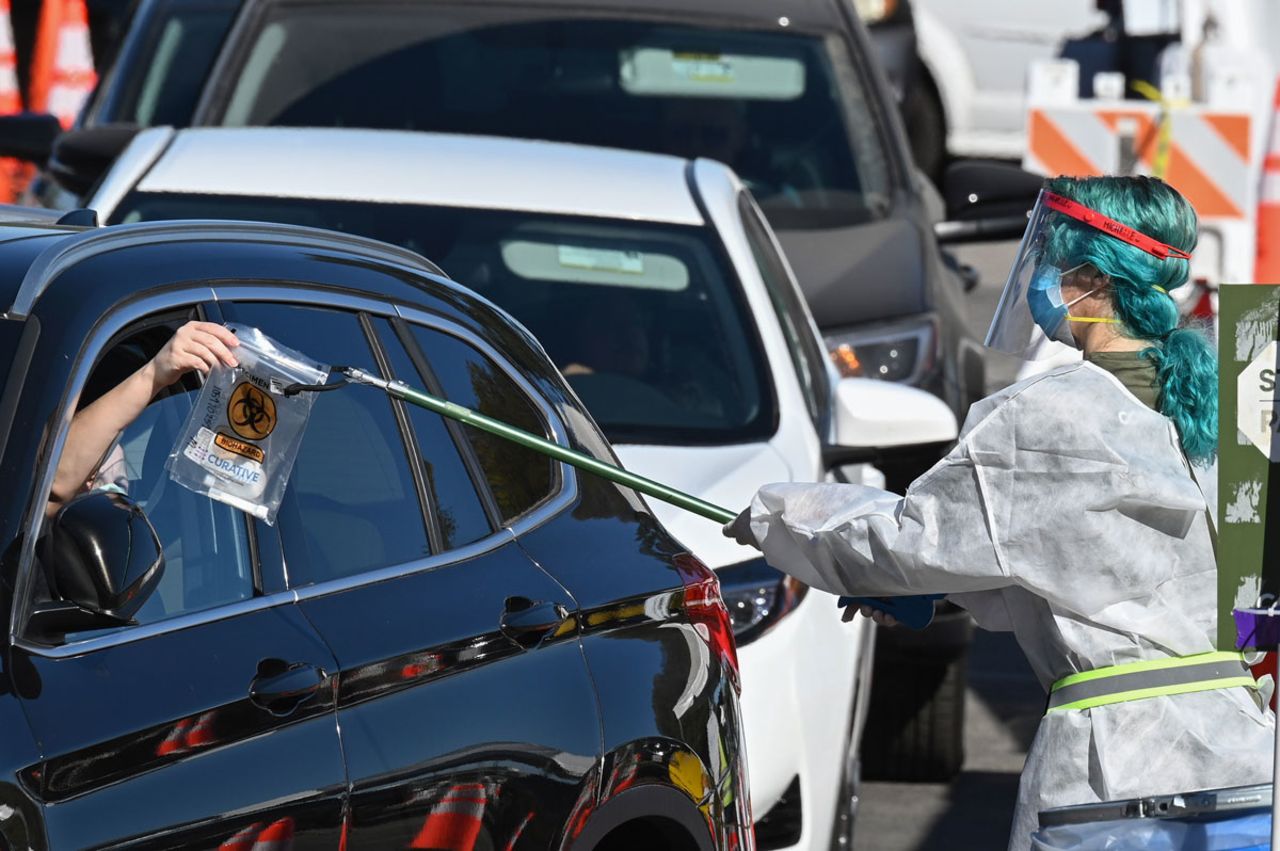 A healthcare worker collects a self-administered coronavirus test at a testing site in Los Angeles, California on November 30 following the Thanksgiving holiday.