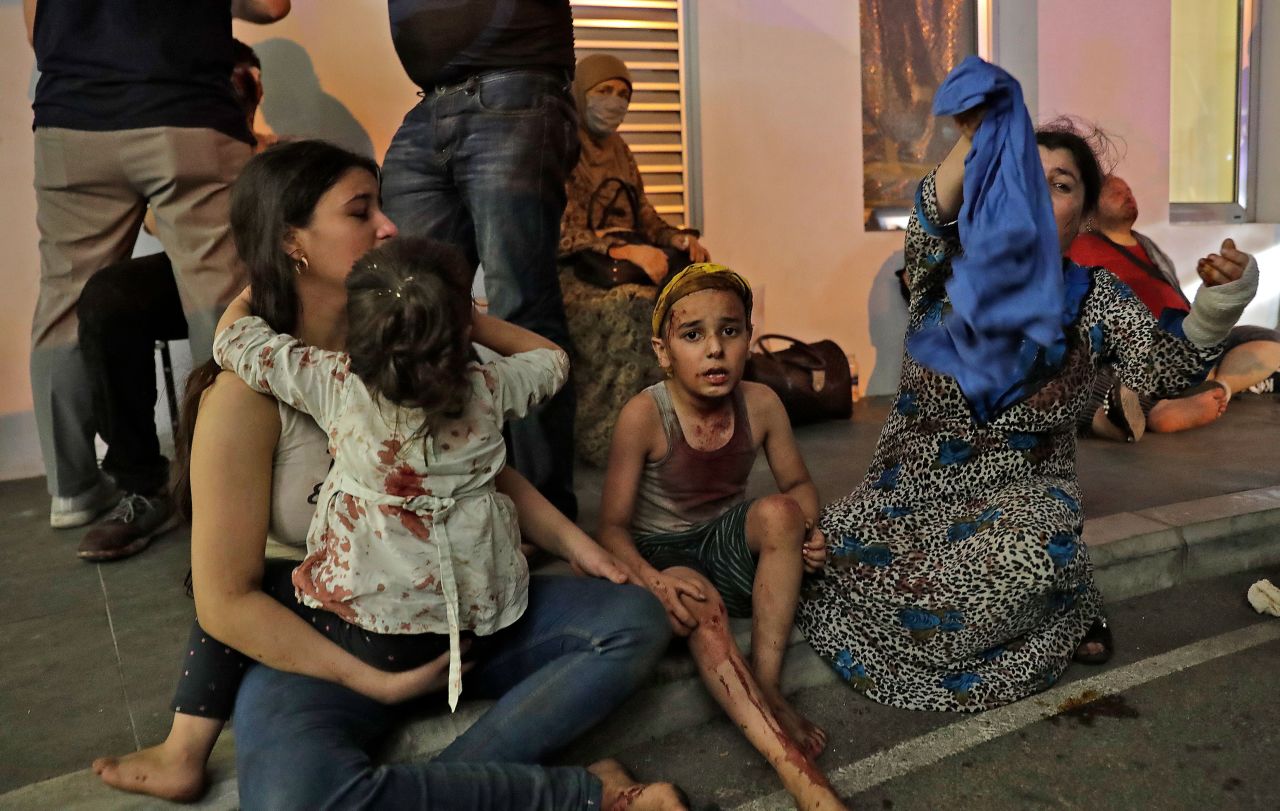 Wounded people wait to receive help outside a hospital on August 4.