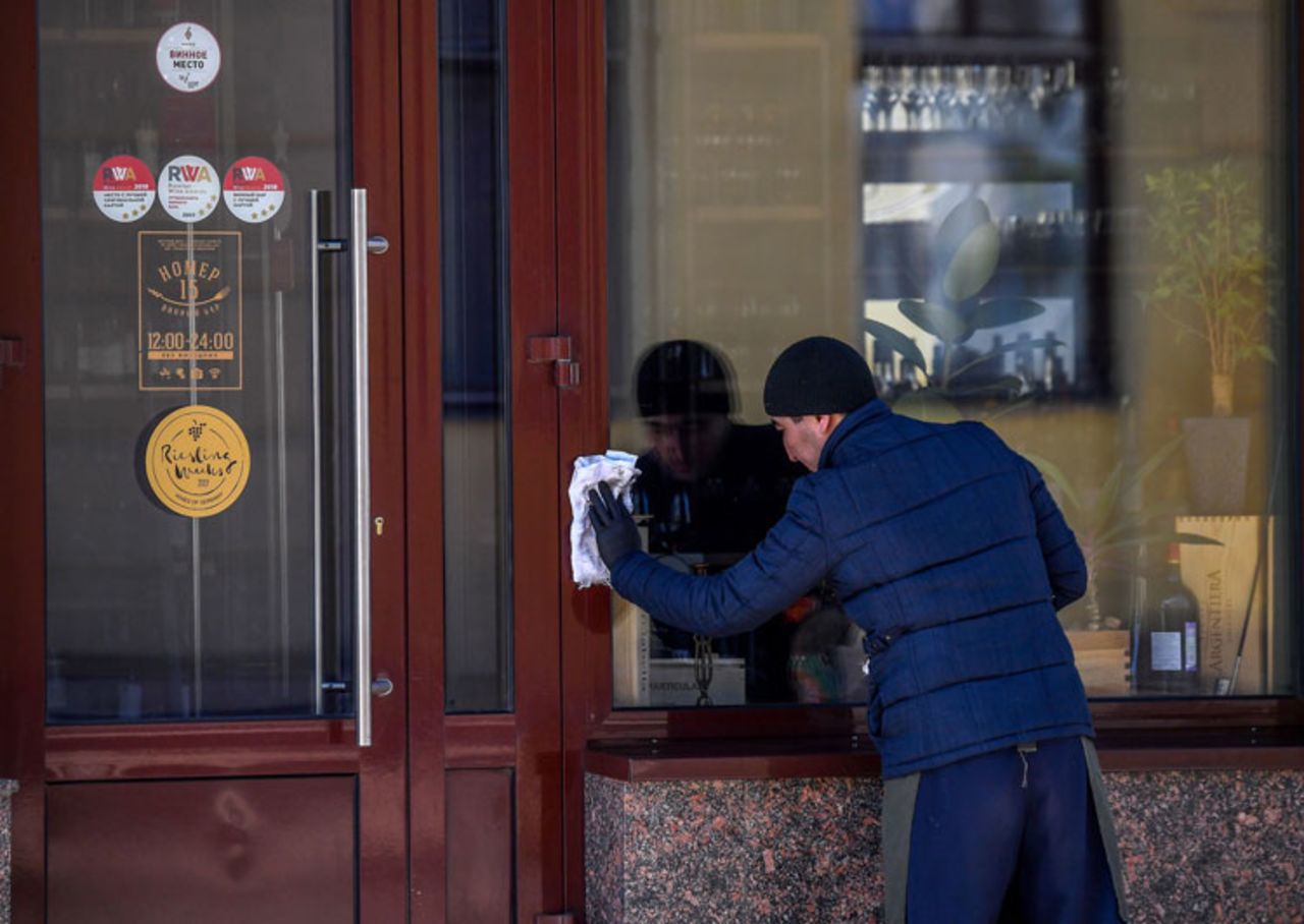 A man cleans a cafe door amid concerns of the coronavirus in central Moscow on March 25.