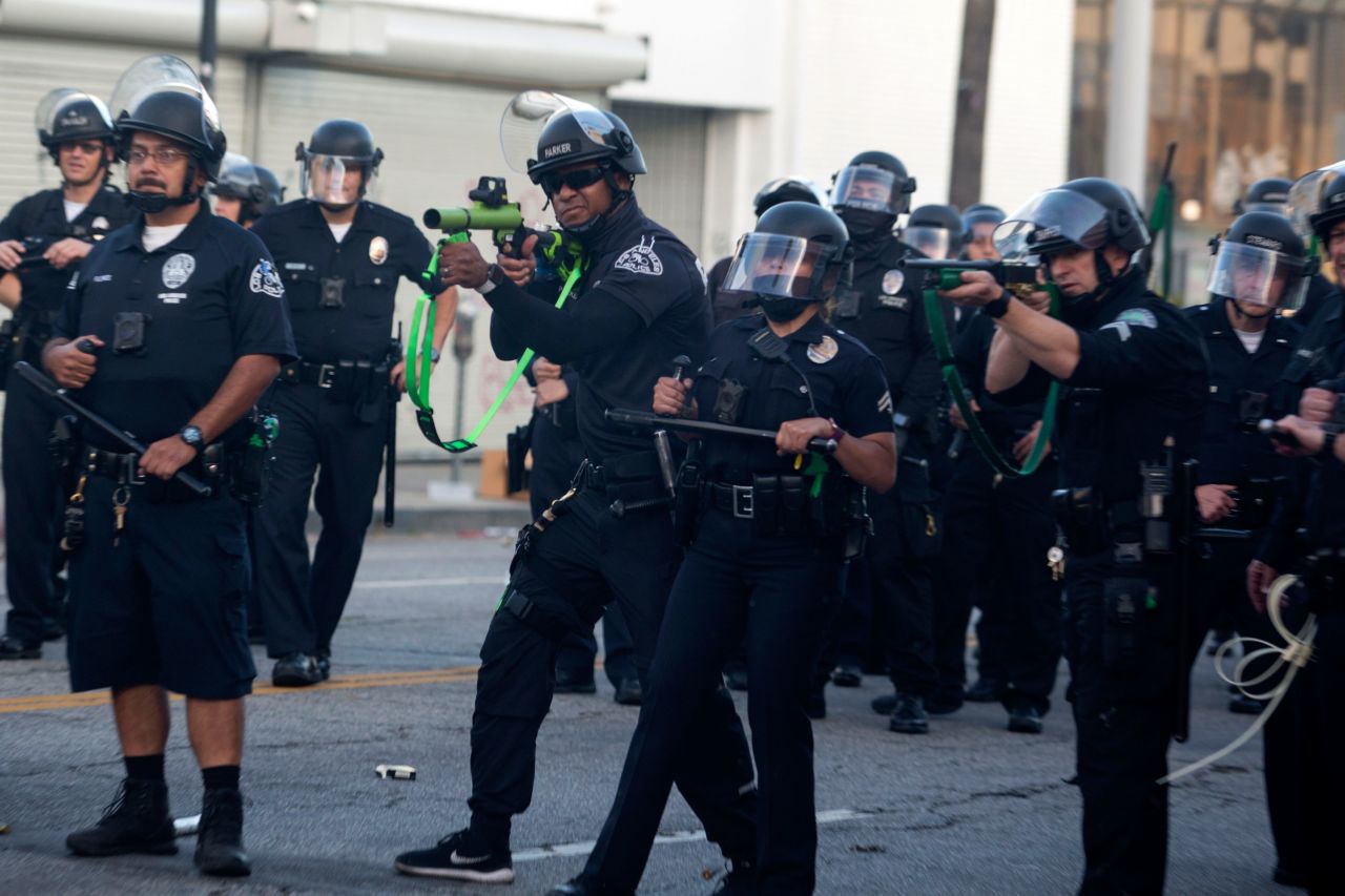 Police officers fire rubber bullets during a protest on Saturday, May 30 in Los Angeles.