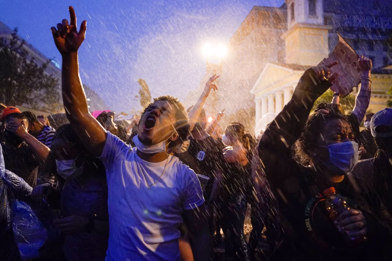 Demonstrators protest in the rain on Thursday night in Washington.