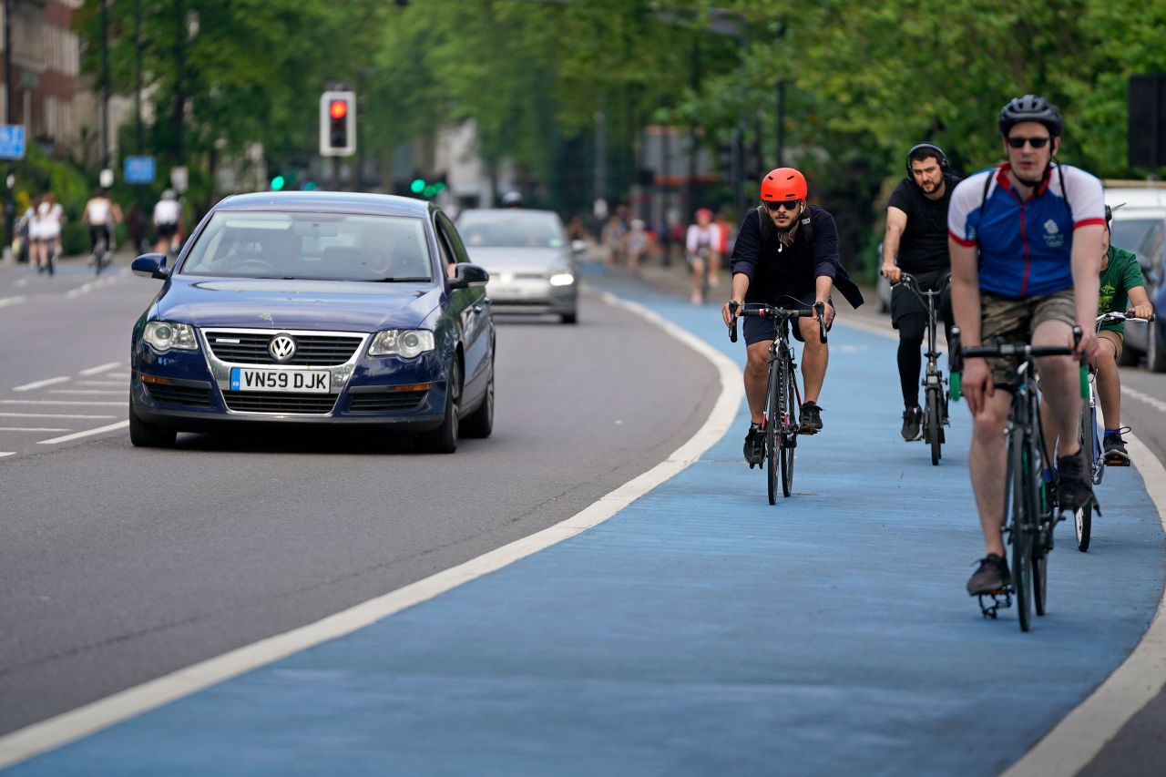 People ride bicycles in a cycle lane in the Chelsea neighborhood of London on May 9.