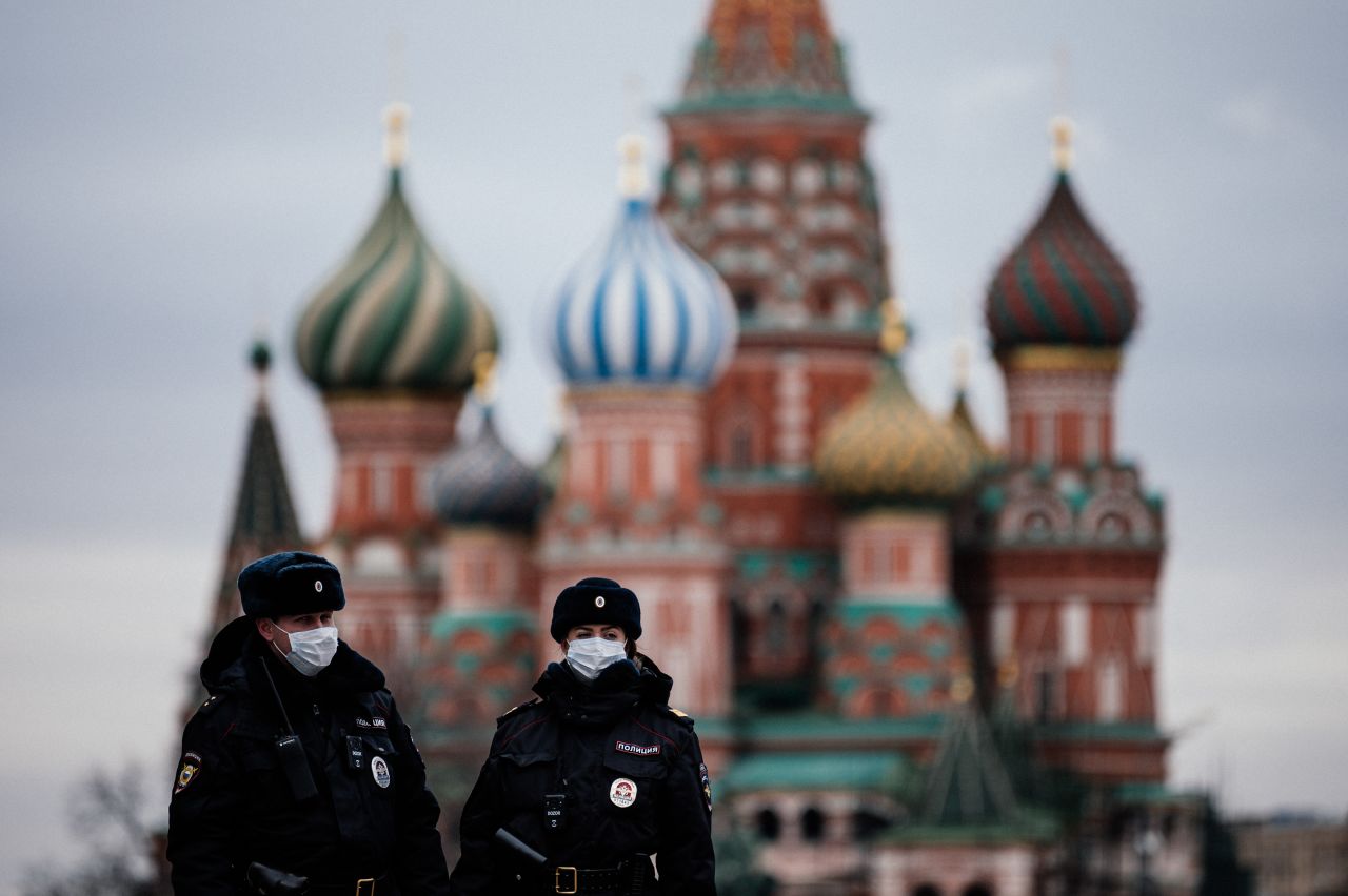 Russian police officers patrol the deserted Red square in front of Saint Basil's Cathedral in Moscow on Monday, March 30, as the city and its surrounding regions imposed lockdowns.