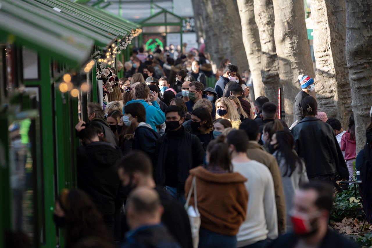 People wearing masks visit the Bank of America Winter Village in Bryant Park in New York City, on December 13.