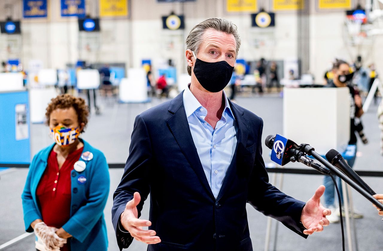 Gov. Gavin Newsom discusses the 2020 election while visiting the Golden State Warriors training facility, which is serving as a polling location, on Tuesday, Nov. 3, in Oakland, Calif. 