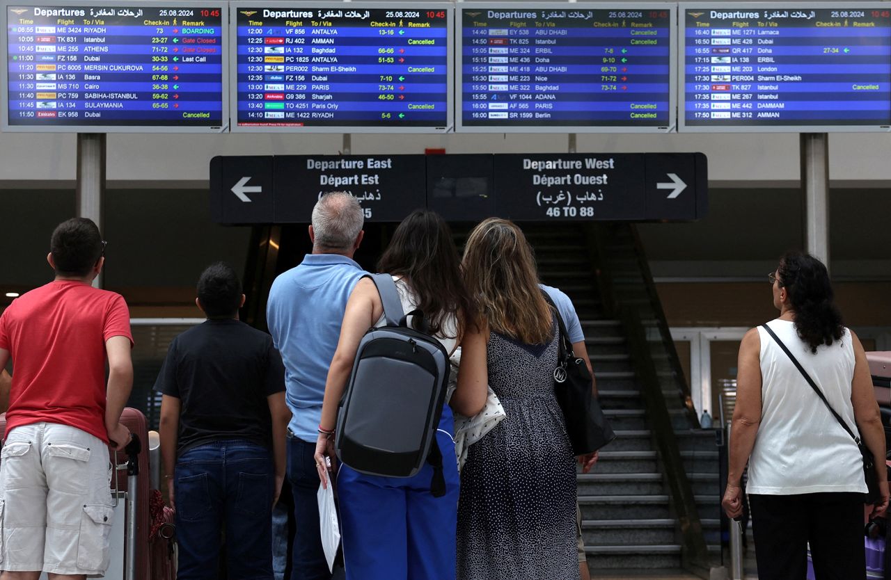 People look at an information board showing some cancelled flights in Beirut, Lebanon, on August 25. 