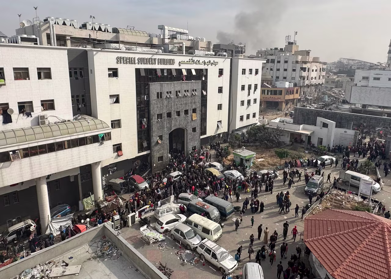 Displaced Palestinians gather in the yard of Al-Shifa hospital in Gaza on December 10, 2023.